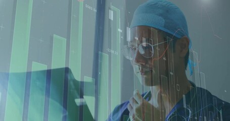 Poster - Animation of financial data processing over asian male doctor holding x-ray scan