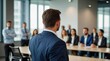 © VistaVisions - Confident businessman giving a presentation in front of crowd in meeting conference seminar room. Leadership authority teamwork in business concept