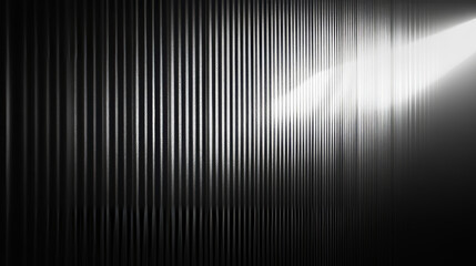 A black and white gradient shines through a textured, see-through glass surface. The light creates a rippling effect on the dark background, making the glass look like a corrugated wall.