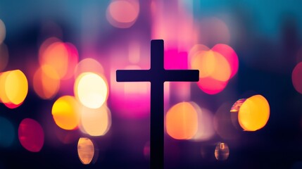 Silhouette of Christian cross with colorful bokeh lights in background