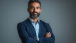 © yang - Proud confident bearded indian business man investor, rich ethnic ceo, corporate executive, professional lawyer banker, male office employee standing isolated on gray with arms crossed. Portrait