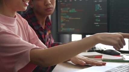 Slow motion back end software developer engineer for computer programming working together on debugging writing computing code, solving complex algorithms display on monitor in office. Burgeoning
