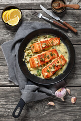 Canvas Print - salmon piccata with lemon caper sauce in a pan