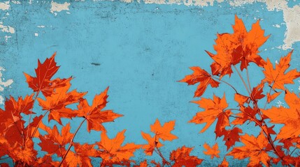 Autumn leaves in vibrant orange hues with a contrasting blue sky featuring maple foliage