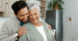 © PeakPoints/peopleimages.com - Home, senior mother and son with hug for care, comfort and assurance with bonding together in kitchen. Happy people, elderly mom and man with embrace for mothers day, support and expression of love