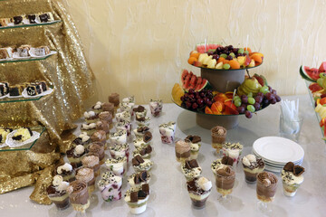 A sweet buffet table with mousses and sweets.