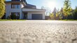© Ponchita - Freshly Paved Concrete Driveway Leading to a Suburban Home, Captured from a Low Angle Perspective