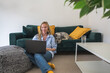 © Cavan - woman freelancer working on laptop with her dog at home