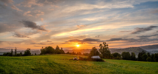 Wall Mural - beautiful sunrise over a mountain meadow in poska near the resort of zakopane