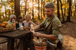 © bernardbodo - Father is breaking bread for his family during a picnic