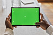 © Cavan Images - African American man using tablet pad with chroma key display