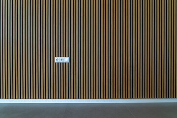 Wooden wall texture with sound absorbing and soundproof background and light switch