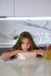 © Inna - Portrait of tired, sad girl falling asleep at table while doing her homework. Child concentrates and focuses on task for elementary school. Back to school. Homeschooling concept. Vertical image.