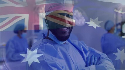 Poster - Animation of flag of australia over african american male surgeon in hospital