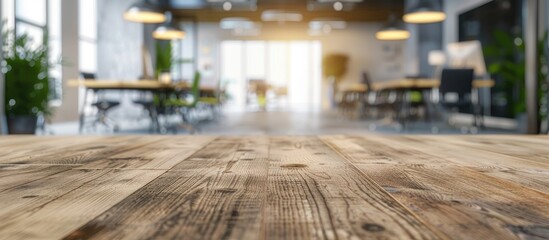 Fototapete - An empty wooden table in a modern office with a blurred background sets a perfect stage for product displays in a copy space image