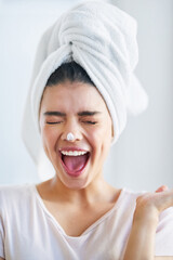 Wall Mural - Beauty, face and lotion with excited woman in bathroom of home for morning skincare routine. Cream, energy and nose with happy person in towel at apartment for antiaging cosmetics or dermatology