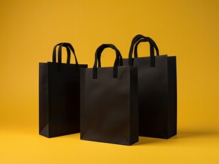 black paper shopping bags on yellow studio background