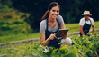 © StarDweller/peopleimages.com - Portrait, farmer and woman with tablet, typing and internet with quality control. Nature, people and employees with plants, tech and inspection for agriculture, sustainability and man with harvest