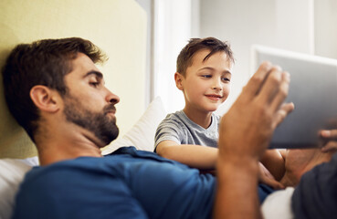 Wall Mural - Relax, tablet and movie with father and son for live streaming, subscription service and technology. Social media, happiness and app with man and child in family home for internet, digital or website