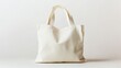 © fotofabrika - Simple white tote bag resting against a light backdrop showcasing its versatile design and practical use for daily errands