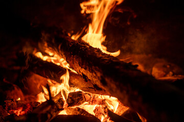 Poster - Flames flicker and crackle as they consume wooden logs, providing warmth and ambiance on a chilly night