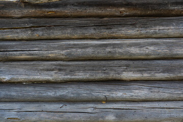 The wall of a wooden hut in the village. Logs background