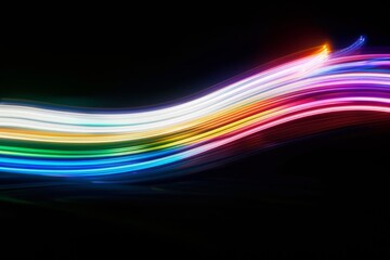 A vibrant light trail in a dark background, capturing the essence of motion and energy through a spectrum of colorful streaks.