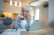 © Dragana Gordic - Senior Woman Working from Home with Laptop and Coffee