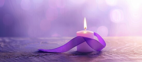 Purple ribbon for cancer awareness campaign with burning candle