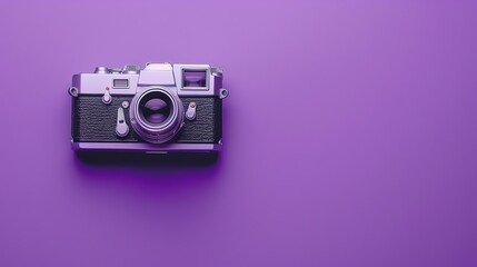 Wall Mural - A vintage film camera on a purple background.