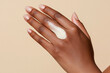 © Luluraschi - black female hand with serum to the back of the other hand, demonstrating the product's texture