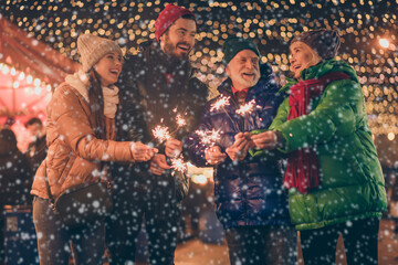 Canvas Print - Portrait of nice attractive cheerful family having fun spending time street urban market newyear celebration burning bengal festal fire custom eve noel spirit outside outdoor