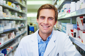 Poster - Man, pharmacist portrait and smile at dispensary, employee and confident chemist at drugstore. Male person, pharmacy and proud of medication treatment at apothecary, service and aisle in England
