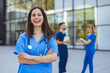 © Dragana Gordic - Smiling Healthcare Professional in Blue Scrubs Outside Hospital