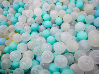 a pile of cyan, white, and transparent plastic balls in the ball pool at the Children's Playground