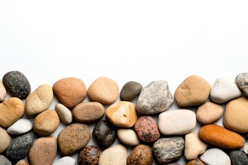 A collection of smooth, colorful stones arranged neatly on a white background, perfect for texture or nature-themed projects.