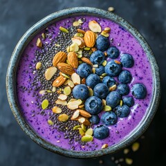 Sticker - Top view of a purple smoothie bowl with blueberries, almonds and chia seeds.