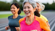 © Tanya - Happy fit and active Asian senior women running at a stadium, proving age is just a number. Sport, fitness, active lifestyle concept.