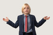 © somemeans - Cute little boy with blond hair in blue suit and red tie with spread hands, isolated over white background
