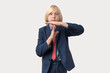 © somemeans - Portrait of a young schoolboy making time out gesture against white background
