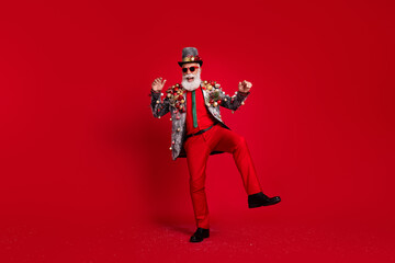 Wall Mural - Full length photo of nice aged elegant man dancing have fun wear christmas tree balls costume sunglasses isolated red color background