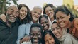 © VK Studio - A large group of people, young and old, laughing and embracing outdoors in a park, radiating genuine happiness and a sense of togetherness.