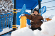 © alexkoral - A Caucasian child is having fun riding down a slide in winter