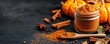 © Weerapat - A cozy arrangement of pumpkin spice in a jar, surrounded by pumpkins and cinnamon on a dark background for autumn vibes.