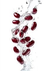 Wall Mural - Red kidney beans splashing in water on white background