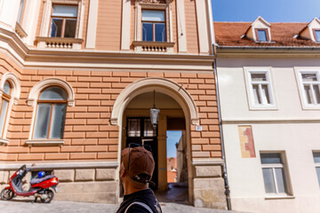 boy looking at the facade of a house