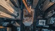 © BerkahStock - Aerial view of a construction site amidst skyscrapers in an urban environment.