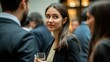 © Supriyanto - A woman engages in conversation at a social gathering, holding a drink.