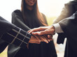 © FotoPush/peopleimages.com - People, graduates and unity with hands together for graduation, motivation or celebration at university. Closeup, group and students piling for teamwork, solidarity or mission on academic future