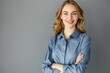 © Virtual Art Studio - Smiling young woman with blonde hair wearing a blue shirt against a gray background.
